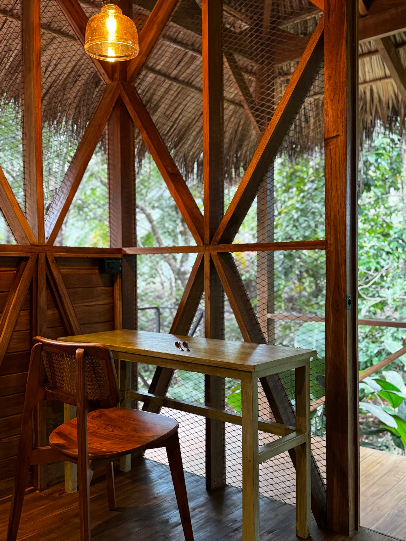 Writing desk inside the wooden academy house overlooking the greenery