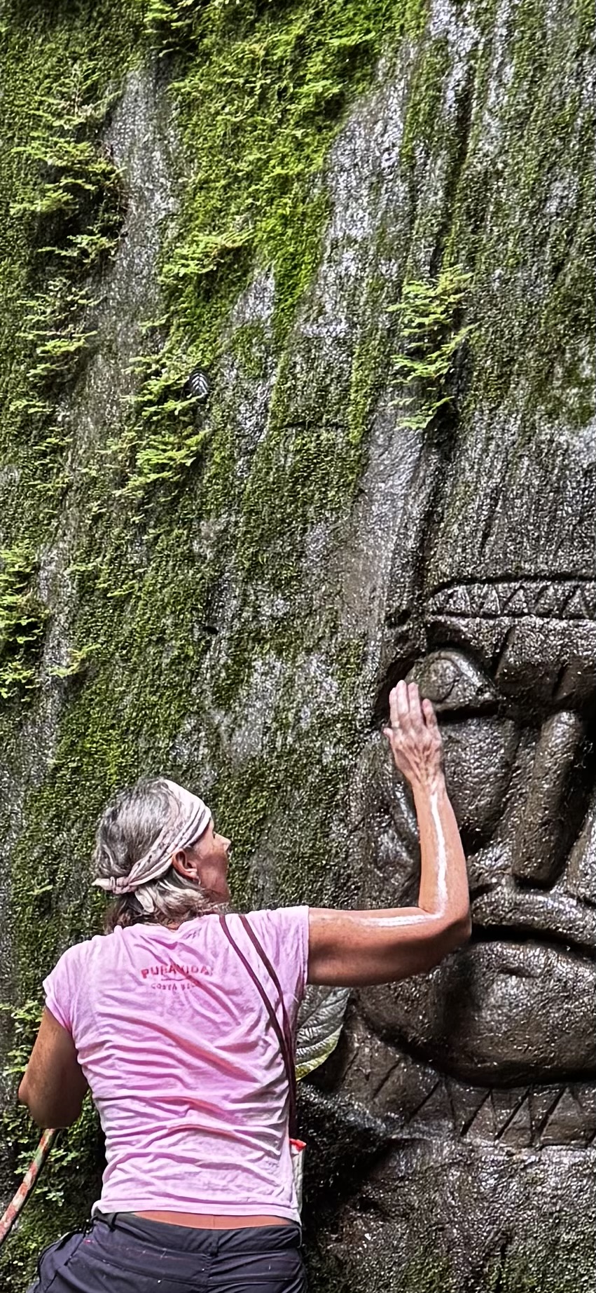 A hand laid upon the eye of a stone guardian carved into the living rock.