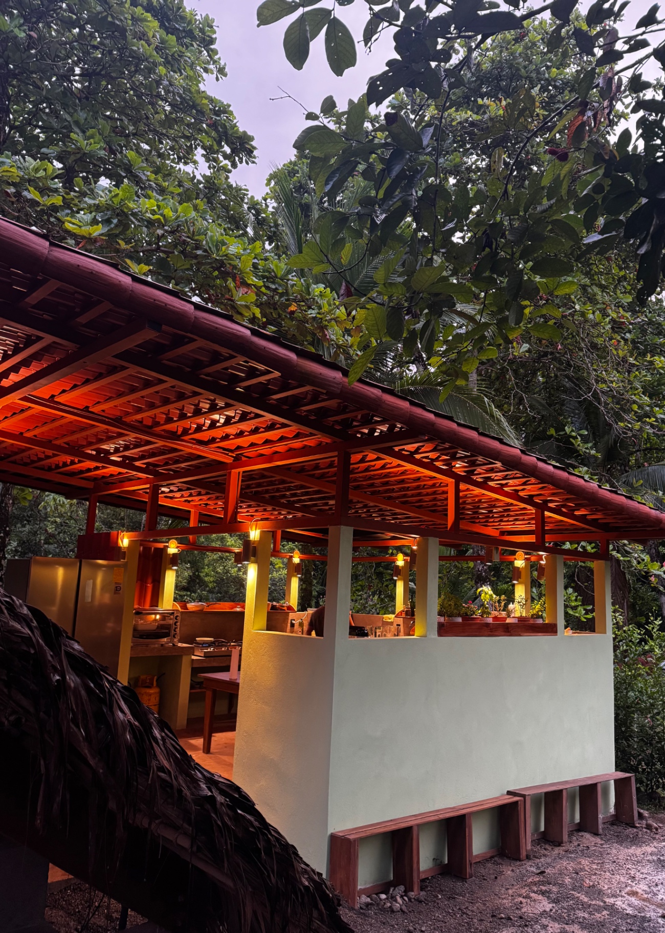 Open jungle kitchen of La Seta at dusk